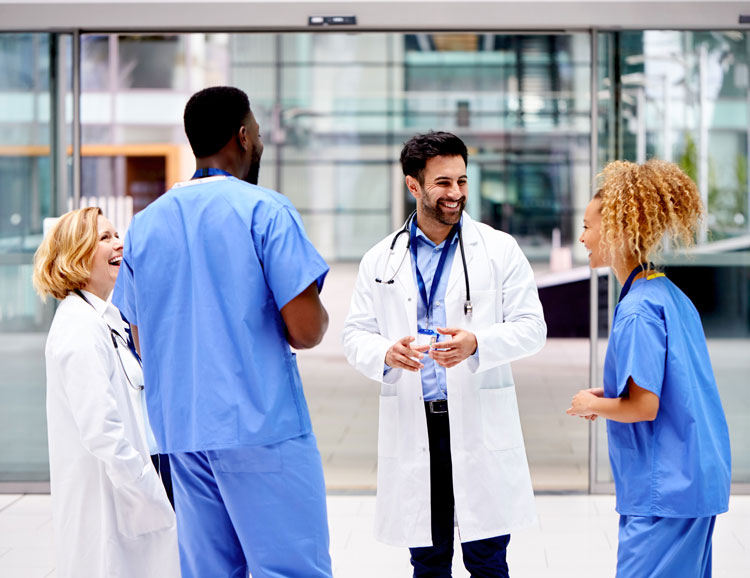 A medical team having an informal meeting outside of a hospital